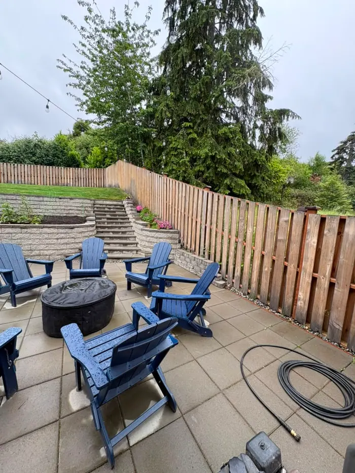 Before photo of long backyard patio fence line before refinishing