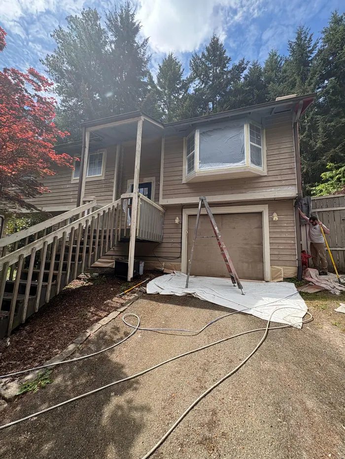 Before photo of front entry garage and stair area before exterior repaint