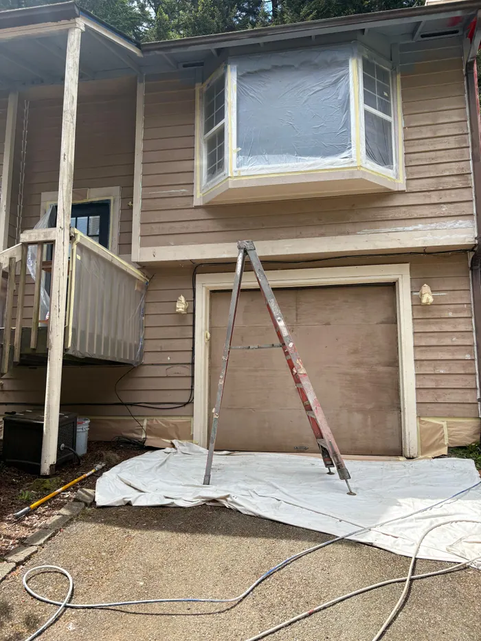 Exterior painting prep around entry trim stairs and siding