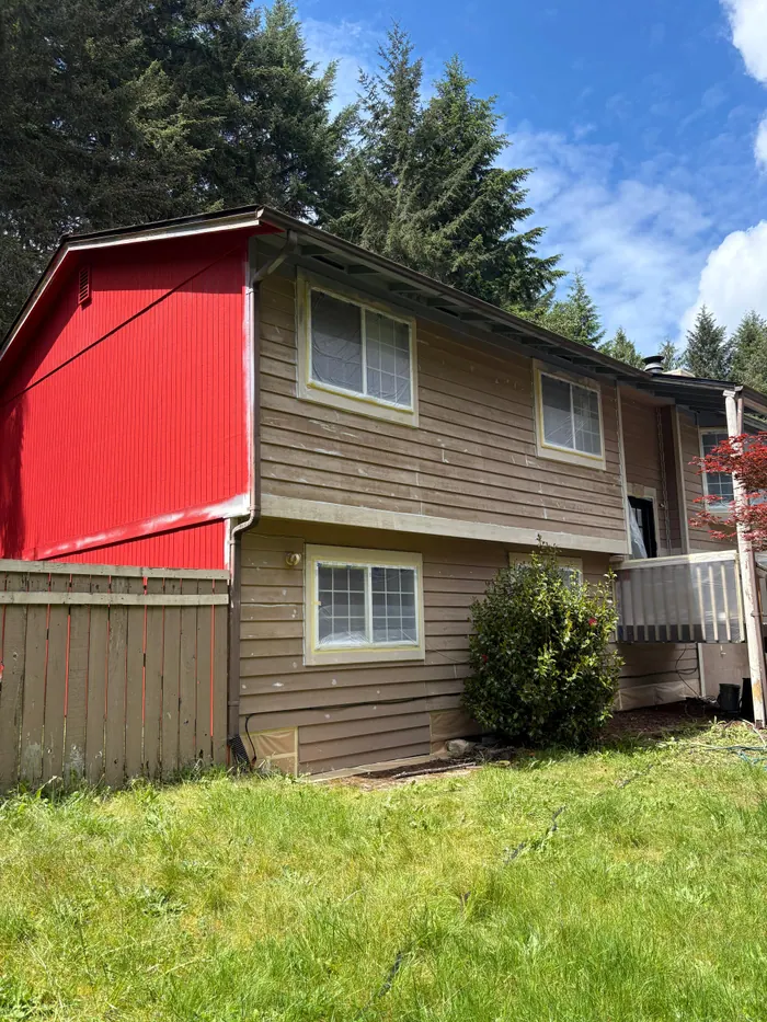 Exterior painting in progress on rear elevation and lower entry