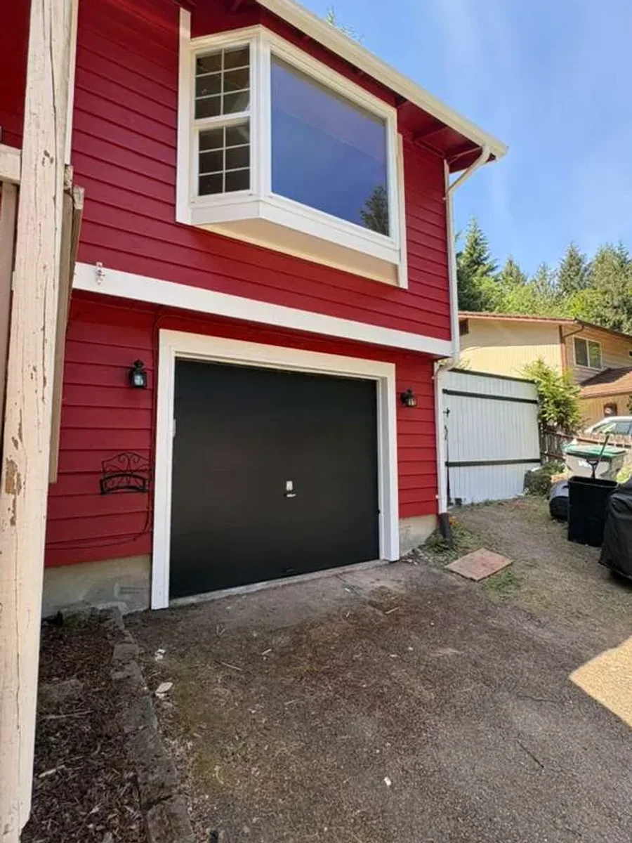 Finished red exterior repaint around front entry and garage